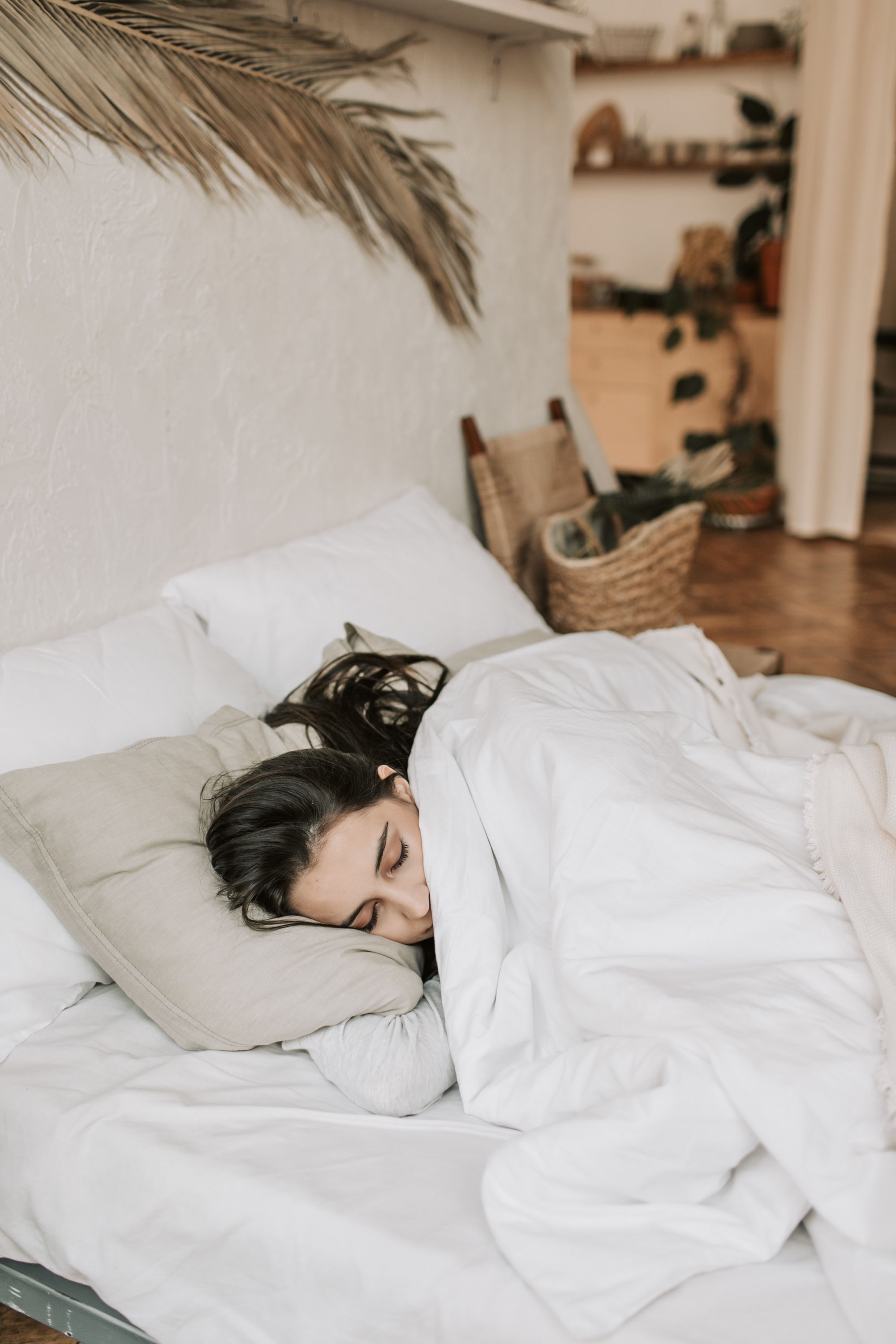 woman comfortably sleeping on bed