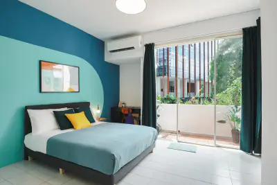 Standard room with a teal feature wall and a big window at Elizabeth Heights