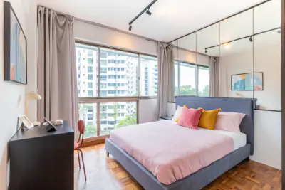 Master ensuite room with a queen bed and pink cushions at Orchid Park