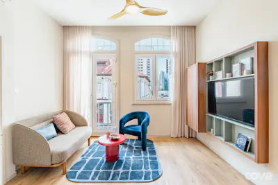 Furnished living room with a sofa and armchair at 111 Jalan Besar