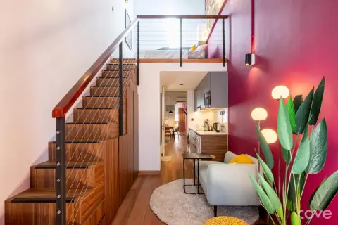 Studio with a mezzanine bed and arched windows at 31-37 Kinta Road