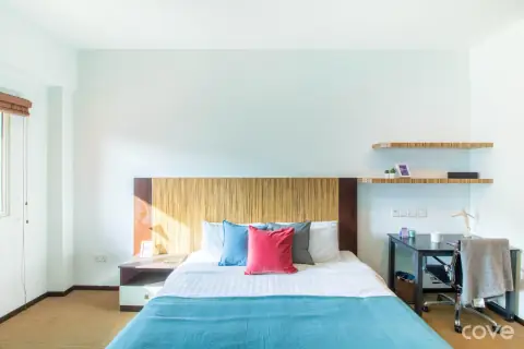 Studio with a queen bed and a sofa at D'Arena in Jurong