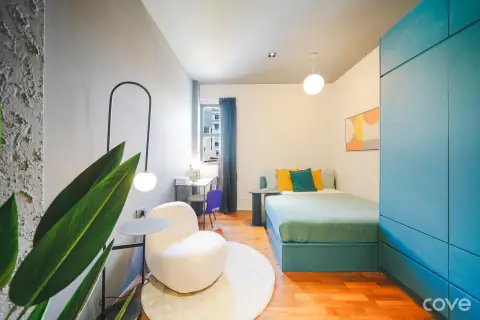 Studio with a queen bed and a work desk at 211 Geylang Road