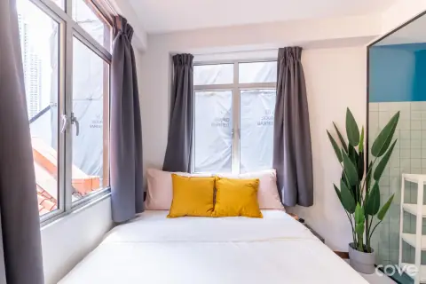 Studio with a queen bed and tall windows at 52 Foch Road