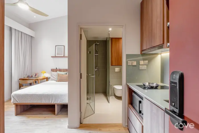 Studio at 111 Jalan Besar with a queen bed, a glass shower and a kitchenette