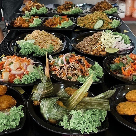 iconinc Thai dishes such as pandan chicken, fried rice, fish cakes, basil chicken and more spread on a table