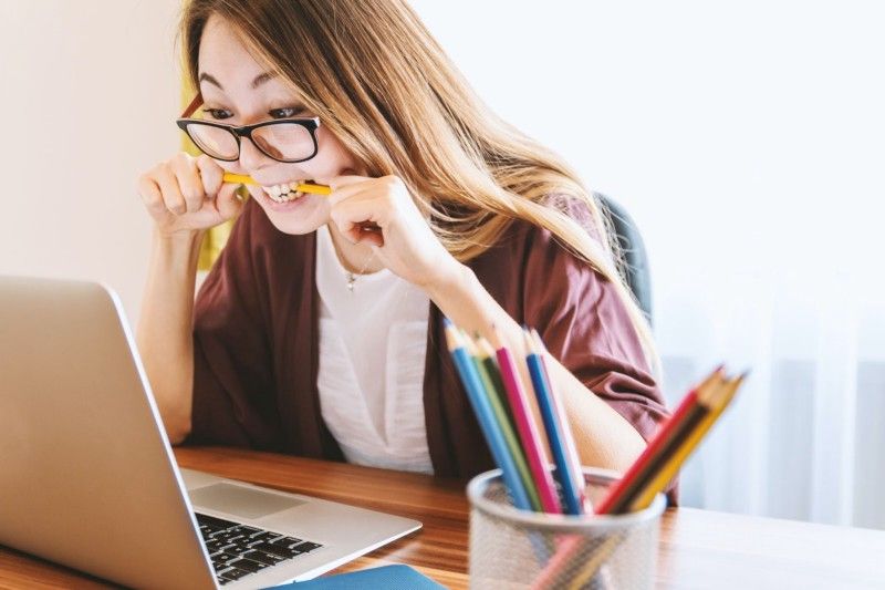 Asian woman stressed over laptop